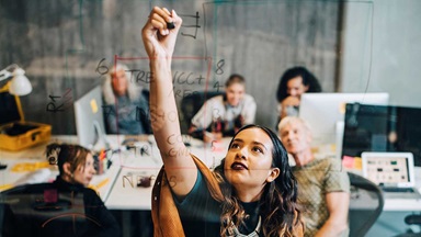 image of a girl writing coding on a clear board