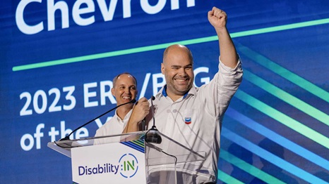 Leo Knittel, president of Chevron’s ENABLED employee network, celebrates on stage during the 2023 Disability:IN Conference in Orlando, FL. ENABLED was named Employee Resource Group of the Year.